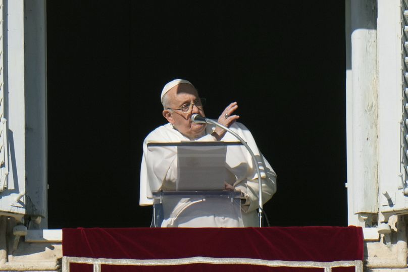 Pope Francis delivers his blessing during the Angelus noon prayer from the window of his studio overlooking St.Peter's Square.