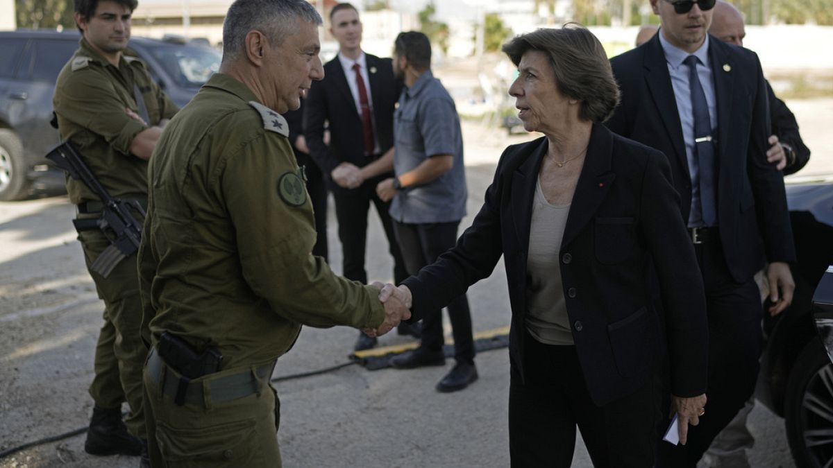 French Foreign Minister Catherine Colonna, right, is greeted by Israeli Col. Olivier Rafowicz as she arrives at the Shura military base, central Israel Sunday Dec. 17, 2023