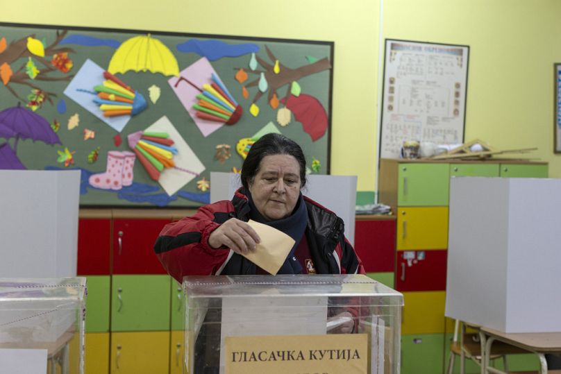 A woman casts her vote at the early parliamentary elections in Belgrade, Serbia, Sunday, Dec. 17, 2023.