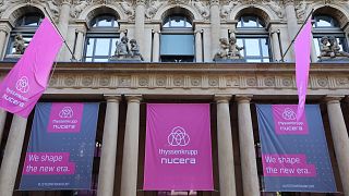 Banners with the logos of German industrial giant Thyssenkrupp and its hydrogen unit Nucera are seen on the facade of the Stock Exchange in Frankfurt am Main on July 7, 2023, 