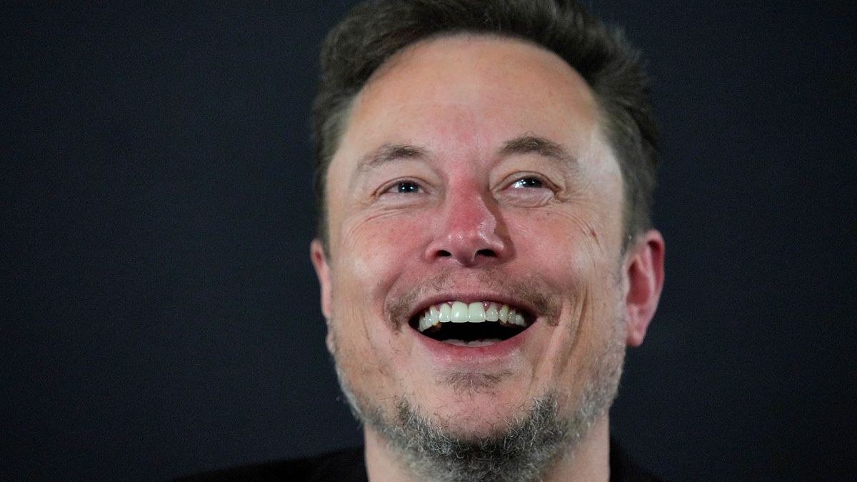 X (formerly Twitter) CEO Elon Musk laughs during an in-conversation event with Britain's Prime Minister Rishi Sunak in London on November 2, 2023, following the UK Artificial 