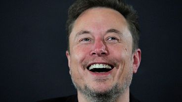 X (formerly Twitter) CEO Elon Musk laughs during an in-conversation event with Britain's Prime Minister Rishi Sunak in London on November 2, 2023, following the UK Artificial 