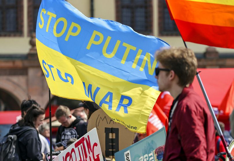 A flag in the colors of the Ukrainian flag is waved during a march in Leipzig, May 2022