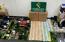 In this photo provided by the Guardia Civil on Friday 15 December 2023, items stolen from suitcases are displayed on the Canary island of Tenerife, Spain. 