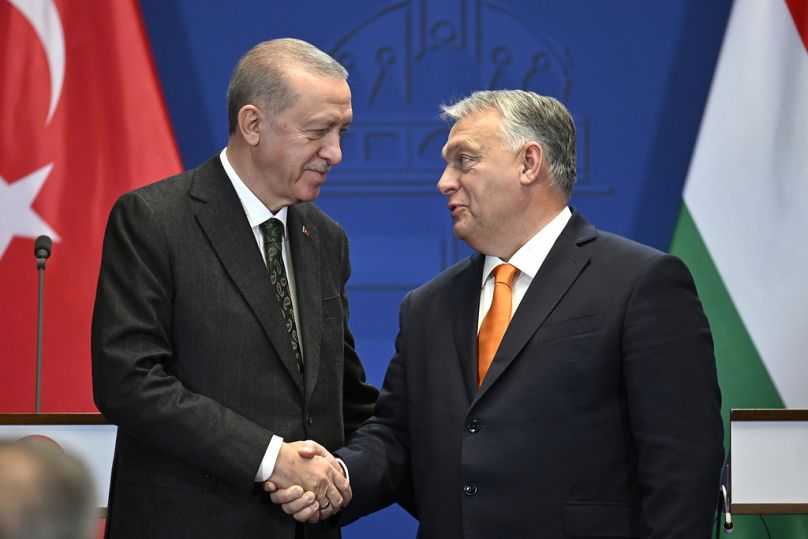 Turkey's President Recep Tayyip Erdogan, left, and Hungary's Prime Minister Viktor Orban shake hands after a joint statement at the Carmelite Monastery in Budapest, Hungary.