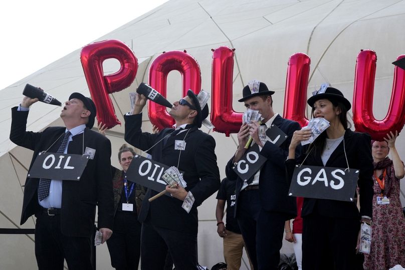 Activists protest against fossil fuels at the COP28 UN Climate Summit in Dubai, December 2023
