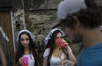 Revelers wearing bride costumes attend the Carmelitas street party in Rio de Janeiro, Brazil, Friday, Feb. 24, 2017. 