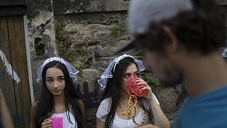 Revelers wearing bride costumes attend the Carmelitas street party in Rio de Janeiro, Brazil, Friday, Feb. 24, 2017. 
