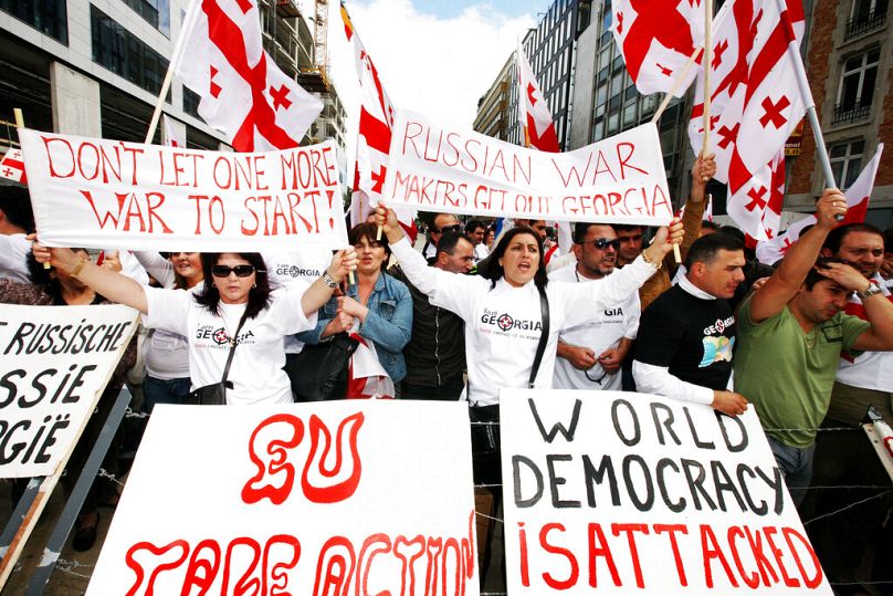 Demonstrators protest about Russia's presence in Georgia outside of an EU summit in Brussels, September 2008
