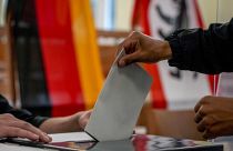 A man casts his ballot for the German elections in a polling station in Berlin, Sept. 26, 2021
