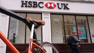 A person walks past an HSBC branch, in London, in March.