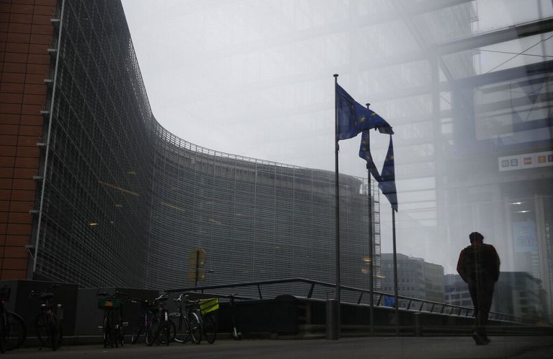 A pedestrian walks past the European Commission headquarters in Brussels, December 2020