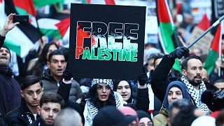 A demonstrator holds up a sign reading 'Free Palestine' during a rally in solidarity with Palestinians in Berlin, Germany, on November 18, 2023