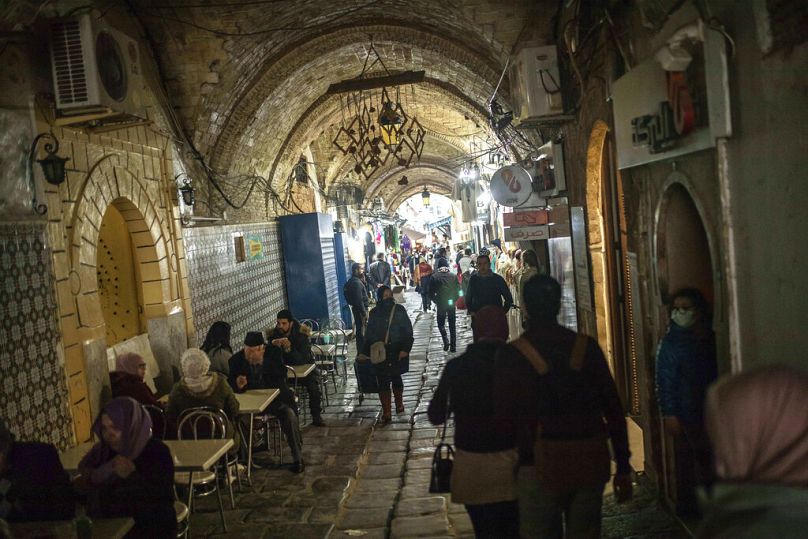 People walk in the old Medina of Tunis, January 2021