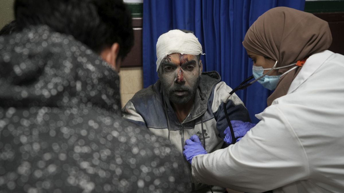Palestinians wounded in the Israeli bombardment of the Gaza Strip are brought to the hospital in Deir al Balah, Gaza Strip, on Tuesday, Dec. 19, 2023.
