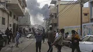 Палестинцы на улицаз города во время обстрела со стороны Израиля