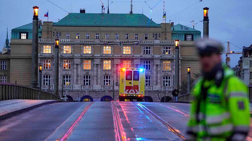 An ambulance drives towards the building of Philosophical Faculty of Charles University in downtown Prague, Czech Republic, Thursday, Dec. 21, 2023.