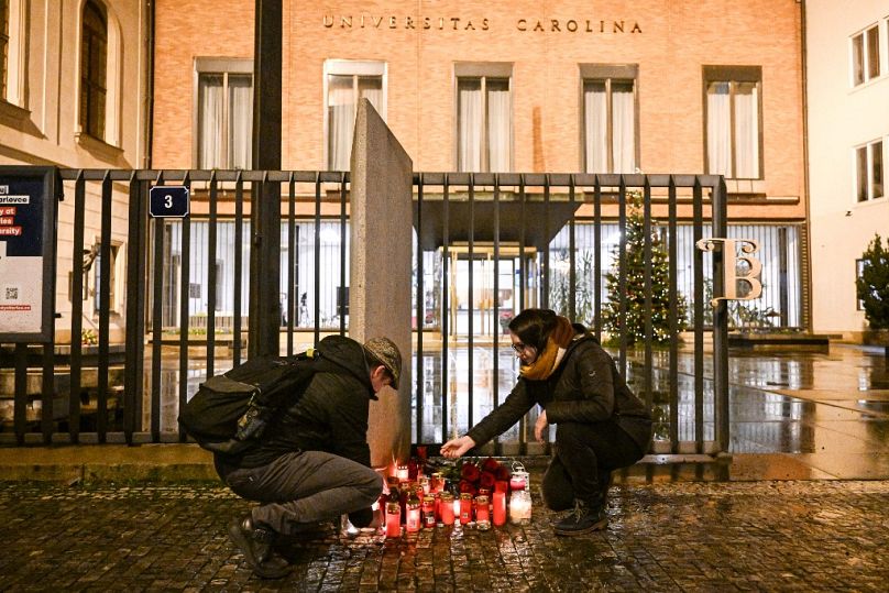 Well wishers light candles for the shooting victims at the Charles University main office in central Prague, on December 21, 2023.