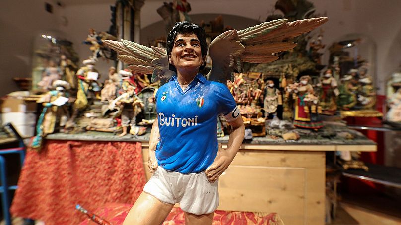 A statuette by Nativity artist Gennaro Di Virgilio portraying soccer legend Diego Armando Maradona with angel's wings in Naples, Italy.