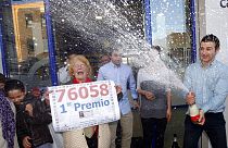 Owners of a lottery office celebrate after selling the first Christmas lottery prize “El Gordo”.