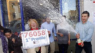 Owners of a lottery office celebrate after selling the first Christmas lottery prize “El Gordo”.