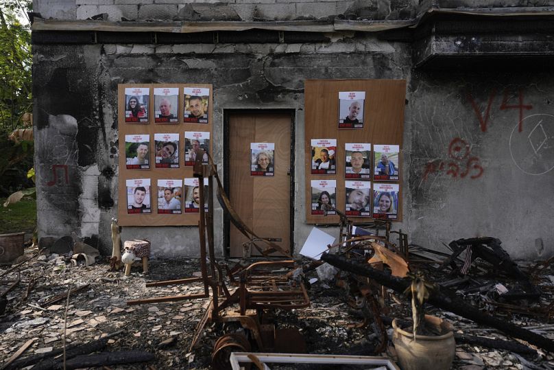 Photographs of Israeli hostages being held in the Gaza Strip are placed on a house that was destroyed by Hamas militants in Kibbutz Be'eri, Israel, Wednesday, Dec. 20, 2023.