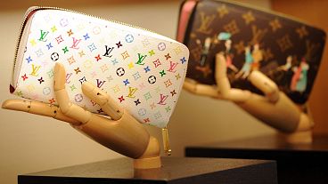 Handbags are displayed in a Louis Vuitton shop on its opening day on January 27, 2012 in Rome. AFP PHOTO / GABRIEL BOUYS Gabriel BOUYS / AFP