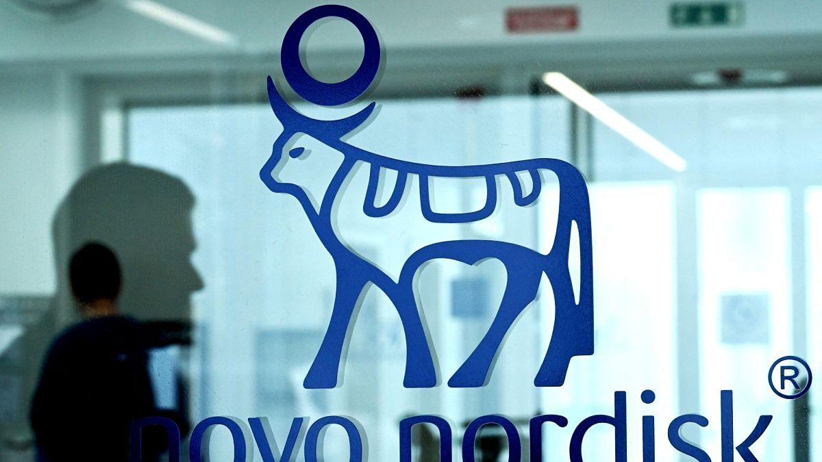An employee walks past a door bearing the logo of Novo Nordisk at the factory in Hilleroed on September 26, 2023. Novo Nordisk is a leading global healthcare company, founded 
