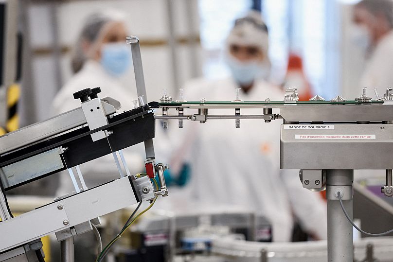 GSL employees are at work at the factory of British pharmaceutical company GlaxoSmithKline (GSK) in Wavre on February 8, 2021 where the Covid-19 CureVac vaccine will be produc