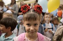 Ukrainian refugee children attend a ceremony marking the beginning of the school year at the Ienachita Vacarescu Elementary School in Bucharest, September 2022
