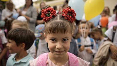 Ukrainian refugee children attend a ceremony marking the beginning of the school year at the Ienachita Vacarescu Elementary School in Bucharest, September 2022