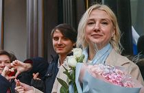 Yekaterina Duntsova, 40-year-old independent politician, holds flowers and poses with supporters outside the Central Election Commission in Moscow, 23 December, 2023