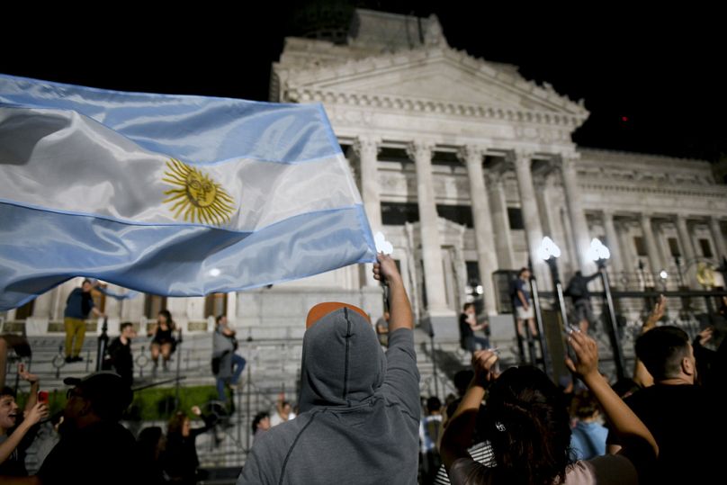 People protest outside the National Congress, following a message from President Javier Milei announcing new economic measures in Buenos Aires, 21 December 2023
