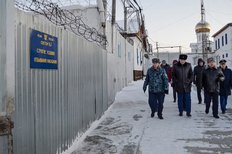 a group of officers walk inside a prison colony in the town of Kharp, in the Yamalo-Nenetsk region.