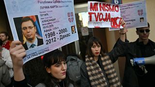 A student holds a placard during a protest in Belgrade, on December 25, 2023