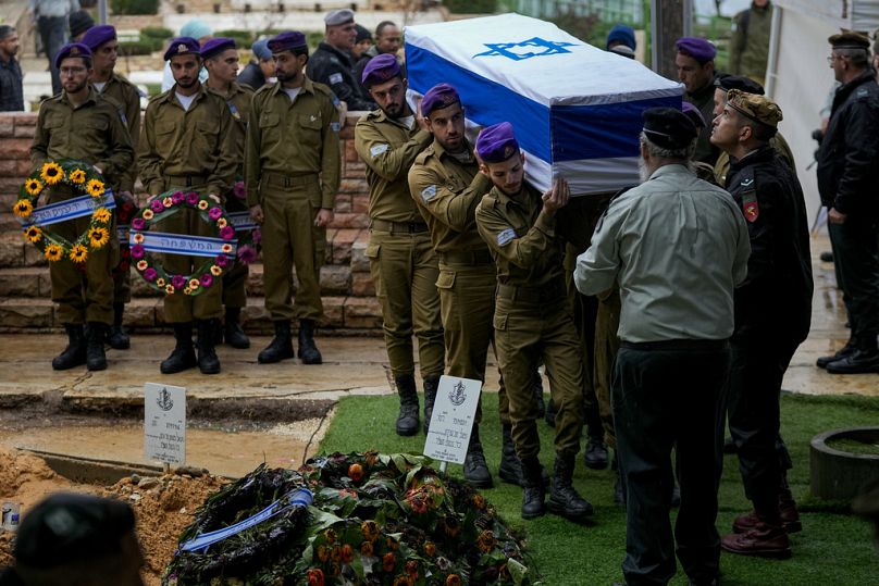 Israeli soldiers carry the flag-draped casket of Staff Sgt. Birhanu Kassie during his funeral at Mt. Herzl military cemetery in Jerusalem, Sunday, Dec. 24, 2023.