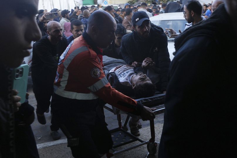 Palestinians wounded in the Israeli bombardment of the Gaza Strip are brought to the hospital in Deir al Balah, Gaza Strip, on Sunday, Dec. 24, 2023.
