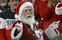 Santa Claus watches the second half of an NFL football game between the Tampa Bay Buccaneers and the Jacksonville Jaguars Sunday, Dec. 24, 2023, in Tampa, Fla. (AP Photo/Jason