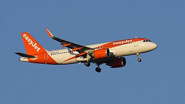 An easyJet Airbus A320 approaches for landing in Lisbon at sunrise, Tuesday, Feb. 7, 2023.