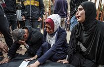 Relatives mourn over the body of a loved one killed during Israeli bombardment at Nasser Hospital in Khan Yunis 