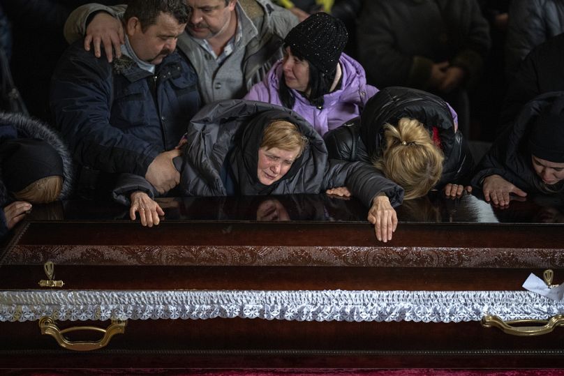 Nadia cries over the coffin of her son Oleg Kunynets, a Ukrainian soldier who was killed in the east of the country, during his funeral in Lviv, February 2023