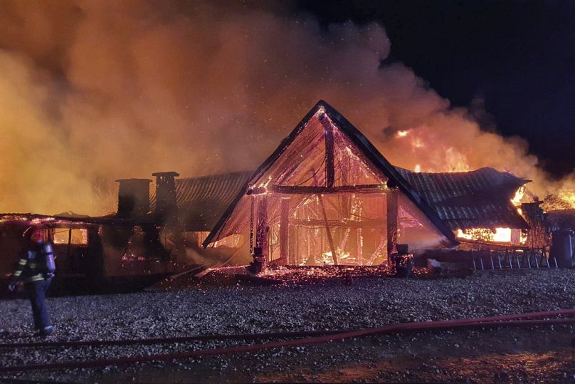 In this photo released by the Romanian Emergency Services Prahova (ISU Prahova), a guesthouse is in flames, in Tohani, Romania, Tuesday, Dec. 26, 2023.