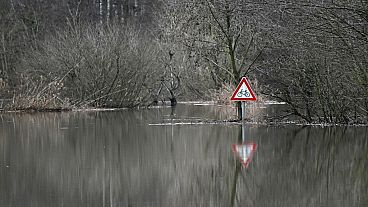 A photo taken on December 27, 2023 shows a traffic sign at the flooded Lippe river in Hamm, western Germany.