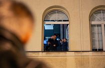 Journalist and protest leader Michal Adamczyk waves to a crowd of protesters at the TVP Info office in Warsaw after staff at public media institutions were dismissed