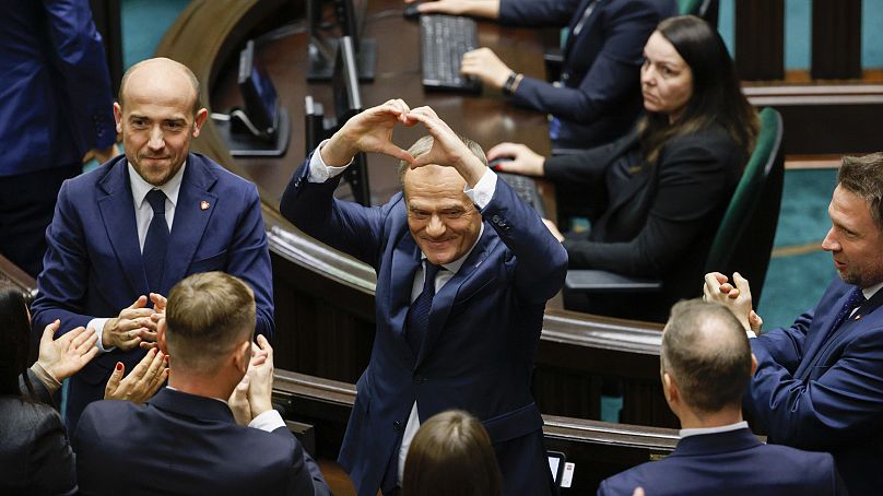 Donald Tusk shows a heart with his hands after being elected as Poland's Prime Minister, December 11