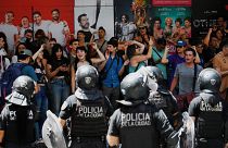 Protesters shouting harangues are guarded by riot police after a demonstration called by Argentina's Labor Union (CGT) 