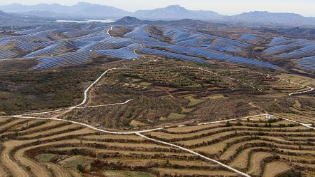 A solar farm operates next to Donggou village in the northern China's Hebei province, 10 November 2023.