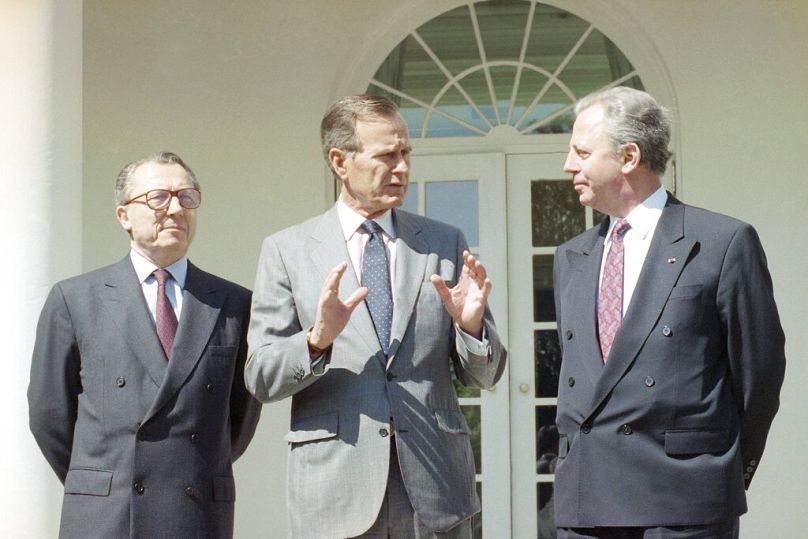 US President George H. Bush talks with Luxembourg PM Jacques Santer and European Community Commission President Jacques Delors in the White House, April 1991