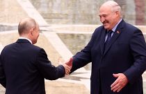 Belarus' President Alexander Lukashenko and Russian President Vladimir Putin greet each other in Minsk, Belarus.