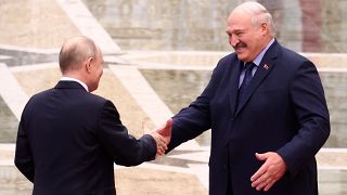 Belarus' President Alexander Lukashenko and Russian President Vladimir Putin greet each other in Minsk, Belarus.